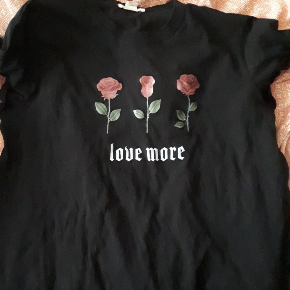 A tee shirt that says love more